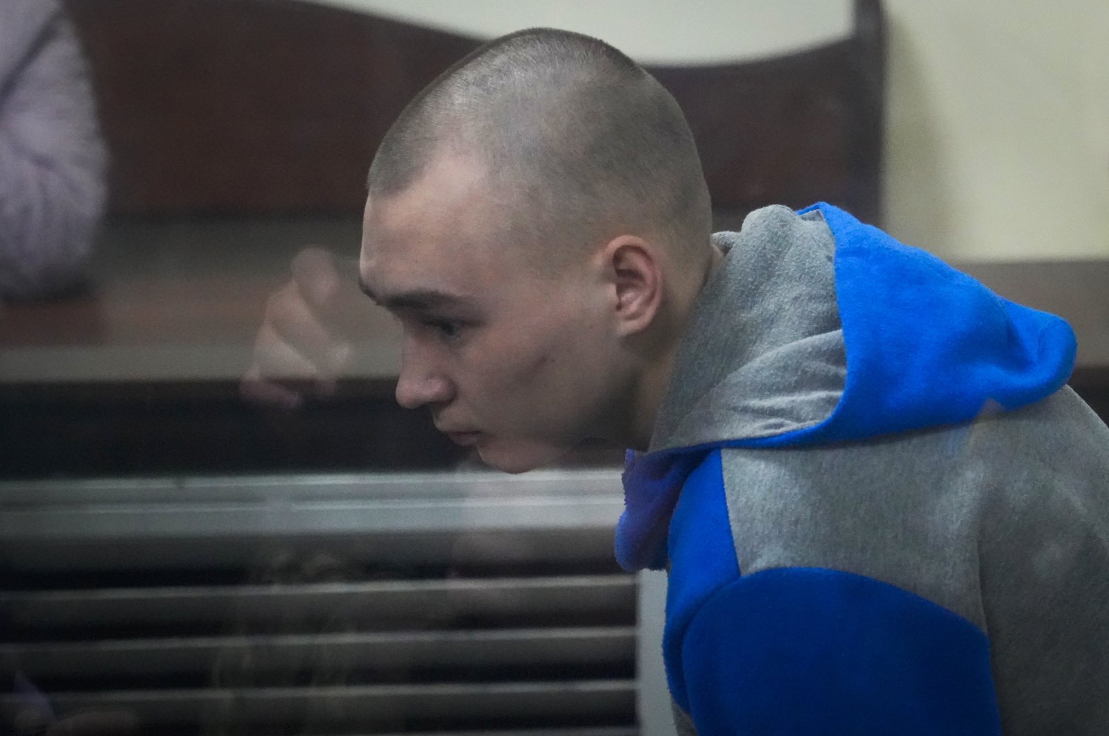 Russian Sgt. Vadim Shishimarin is seen behind glass during a court hearing in Kyiv, Ukraine, May 18, 2022. (AP Photo)