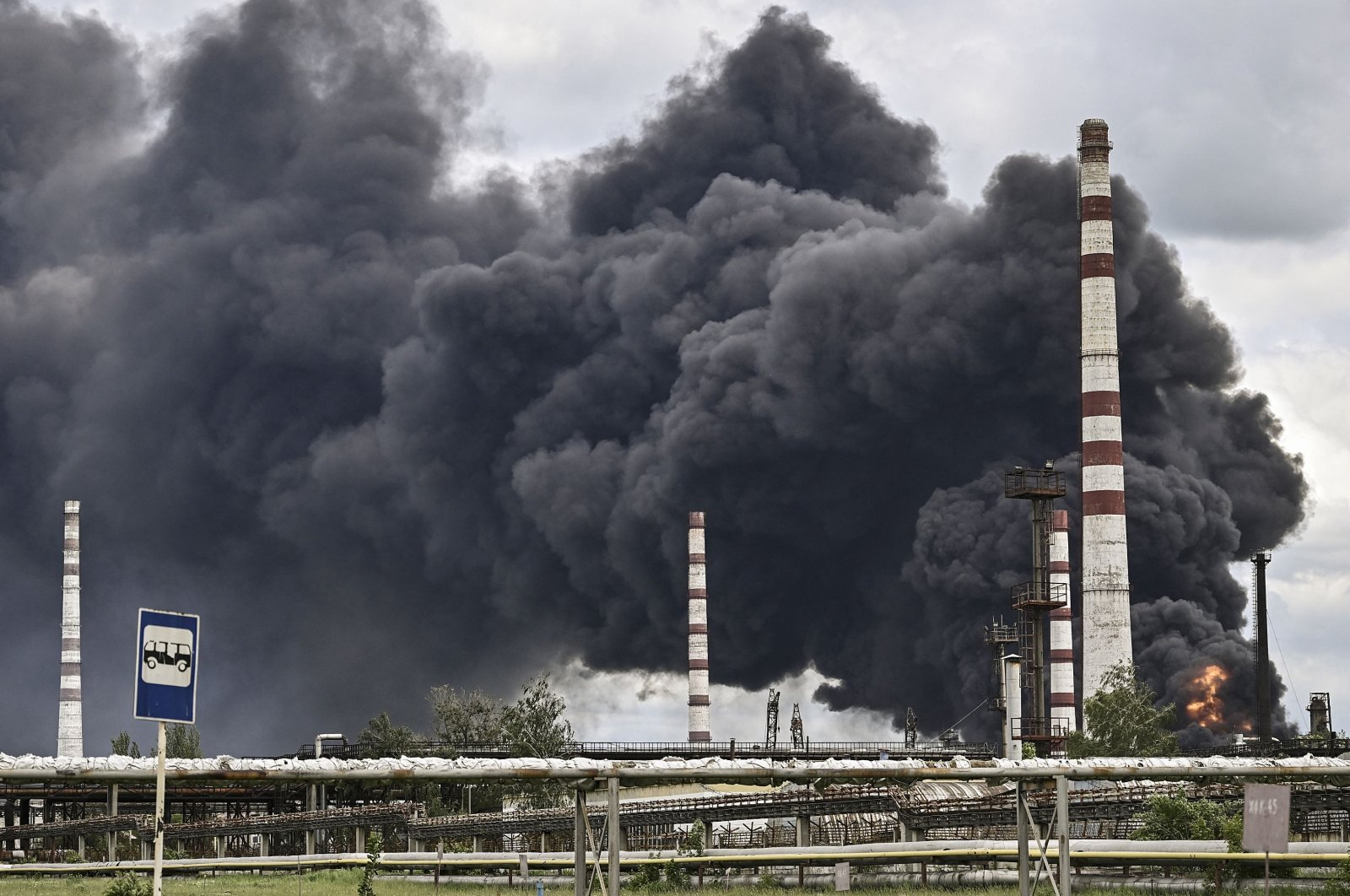 Smoke rises from an oil refinery after an attack outside the city of Lysychans in the eastern Donbass region, Ukraine, May 22, 2022. (AFP Photo)