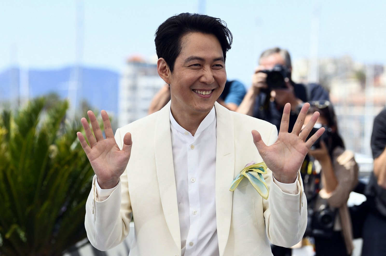 Lee Jung-jae poses for photographers at the photocall for the film &quot;Hunt&quot; at the 75th international film festival, Cannes, southern France, May 19, 2022. (Reuters Photo)