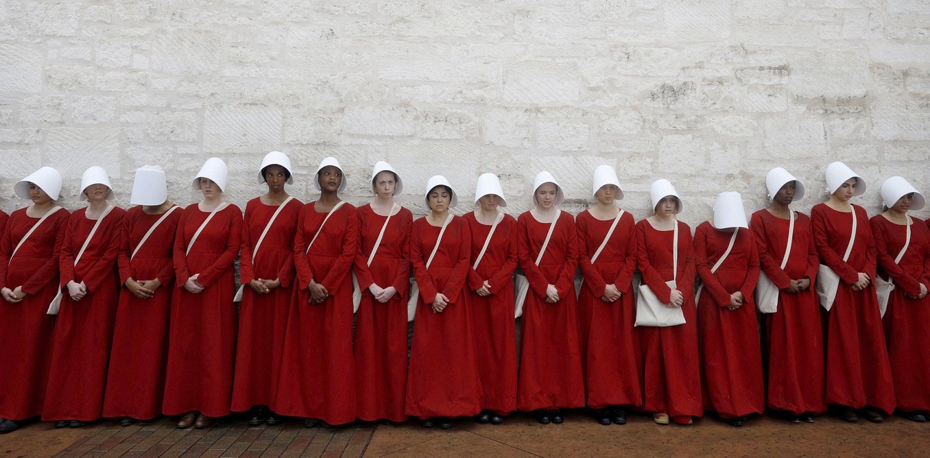 Women dressed as handmaids promoting the Hulu original series &quot;The Handmaid&#039;s Tale&quot; stand along a public street during the South by Southwest (SXSW) Music Film Interactive Festival 2017 in Austin, Texas, U.S., March 11, 2017. (Reuters Photo)