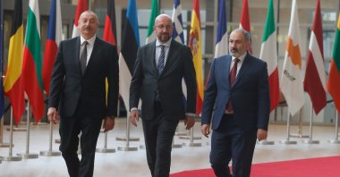 Azerbaijani President Ilham Aliyev (L) and Armenian Prime Minister Nikol Pashinian are welcomed by European Council President Charles Michel (C) in Brussels, Belgium, May 22, 2022. (EPA Photo)