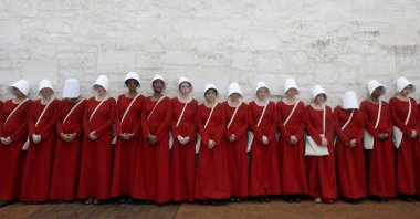 Women dressed as handmaids promoting the Hulu original series &quot;The Handmaid&#039;s Tale&quot; stand along a public street during the South by Southwest (SXSW) Music Film Interactive Festival 2017 in Austin, Texas, U.S., March 11, 2017. (Reuters Photo)