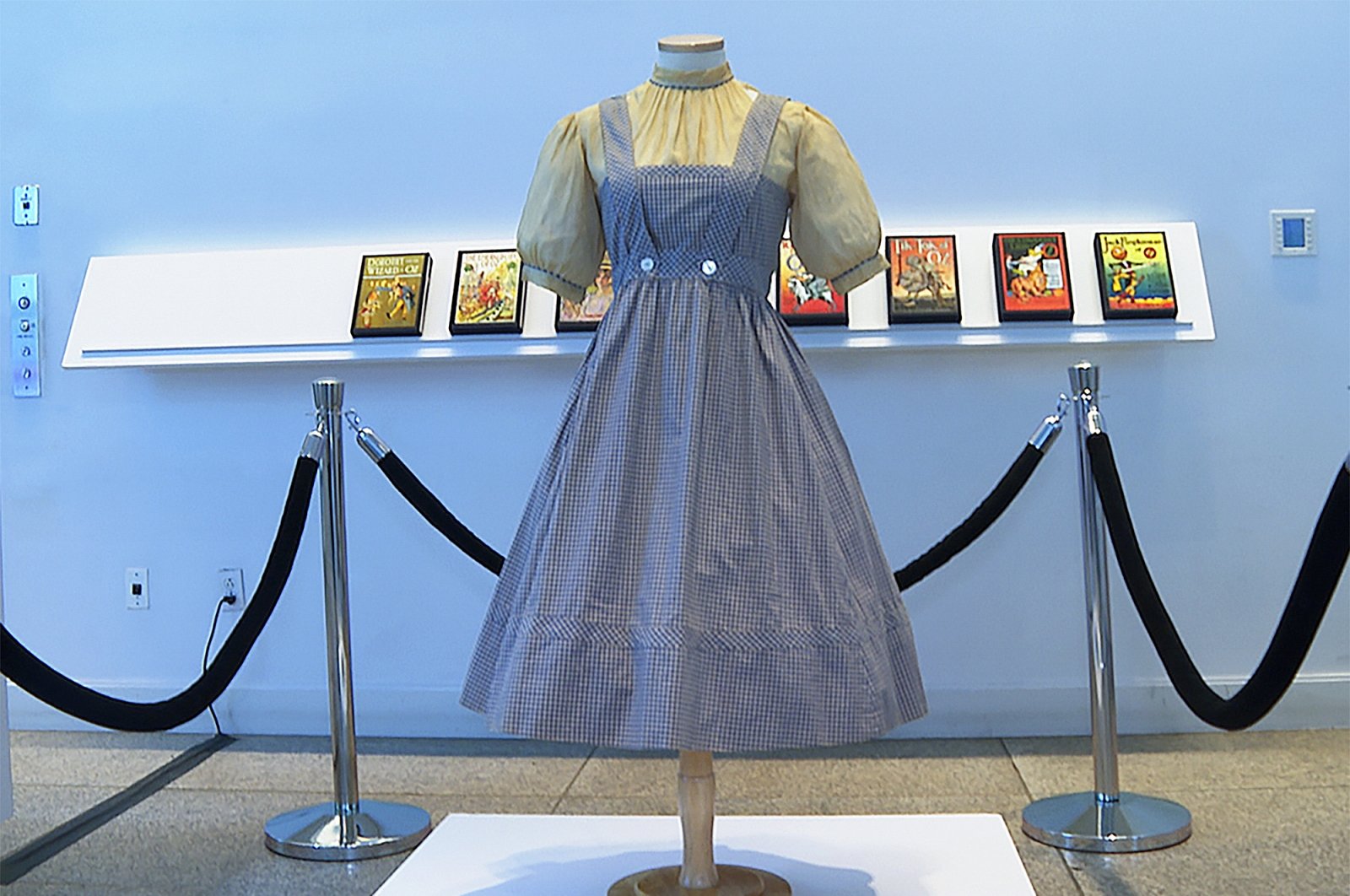 A blue and white checked gingham dress, worn by Judy Garland in the &quot;Wizard of Oz,&quot; hangs on display, at Bonhams in New York, U.S., April 25, 2022. (AP Photo)