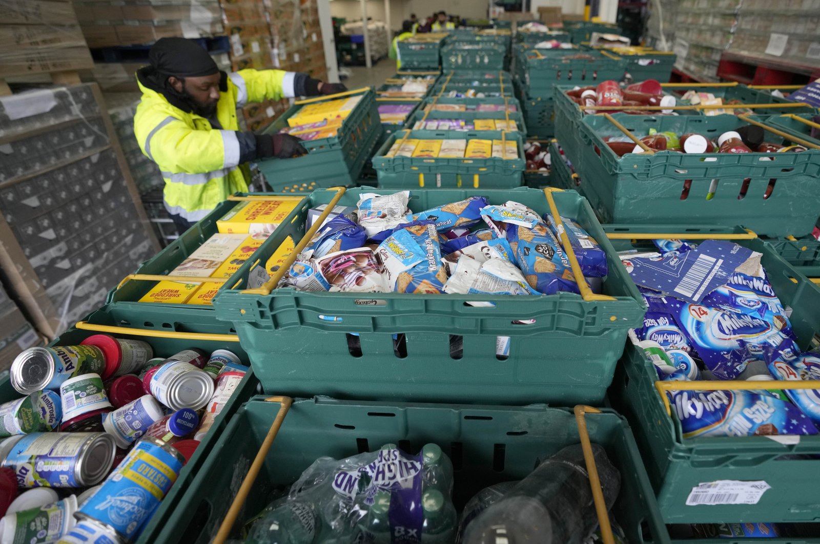 A volunteer from the charity &quot;The Felix Project&quot; collects food at their storage hub in London, May 4, 2022. (AP Photo)