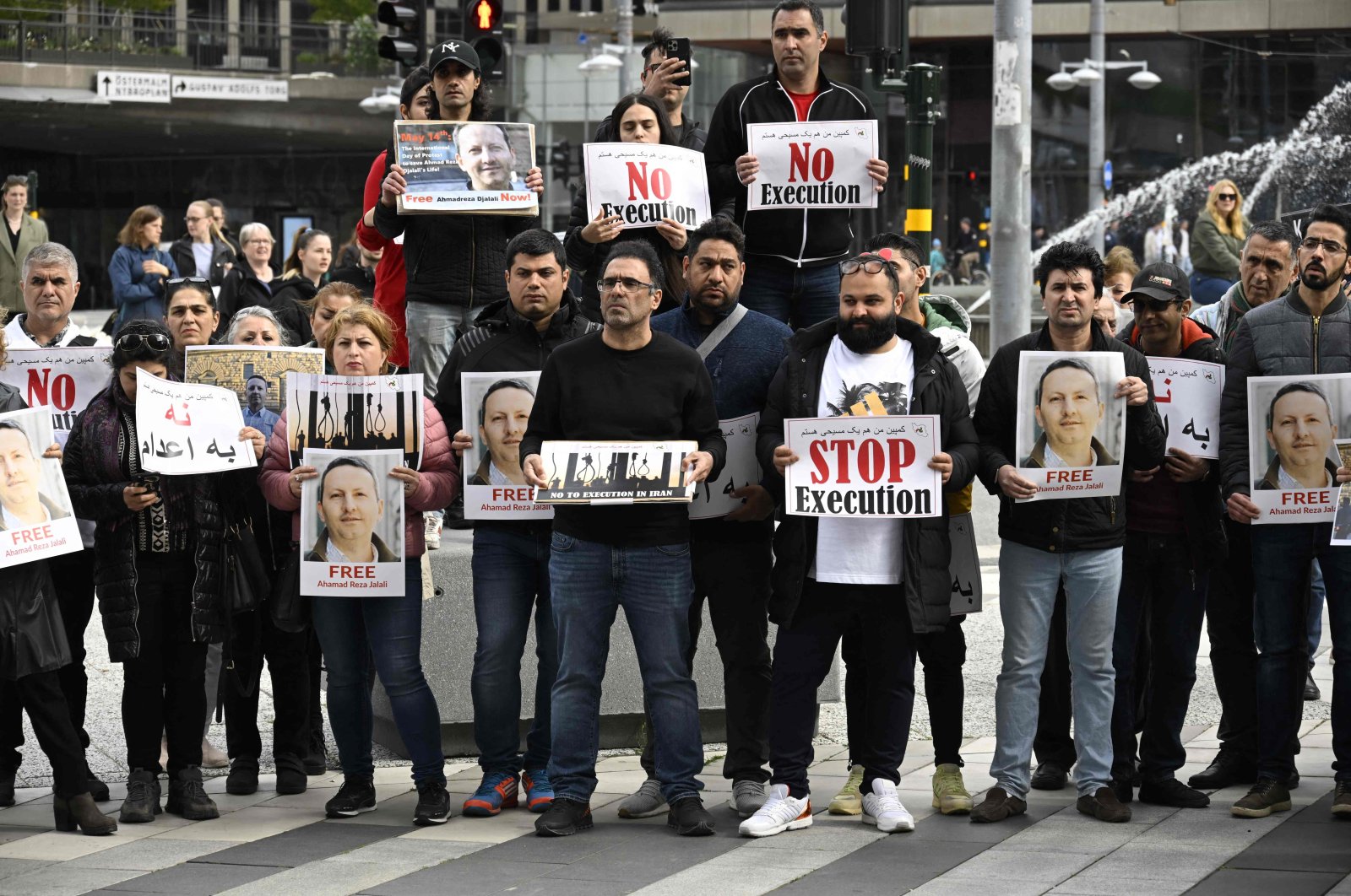 Demonstrators hold posters with a portrait of Swedish-Iranian doctor and researcher Ahmadreza Djalali (Ahmad Reza Jalali) who is imprisoned and sentenced to death in Iran, during a protest calling to free him, Stockholm, Sweden, May 14, 2022. (AFP Photo)