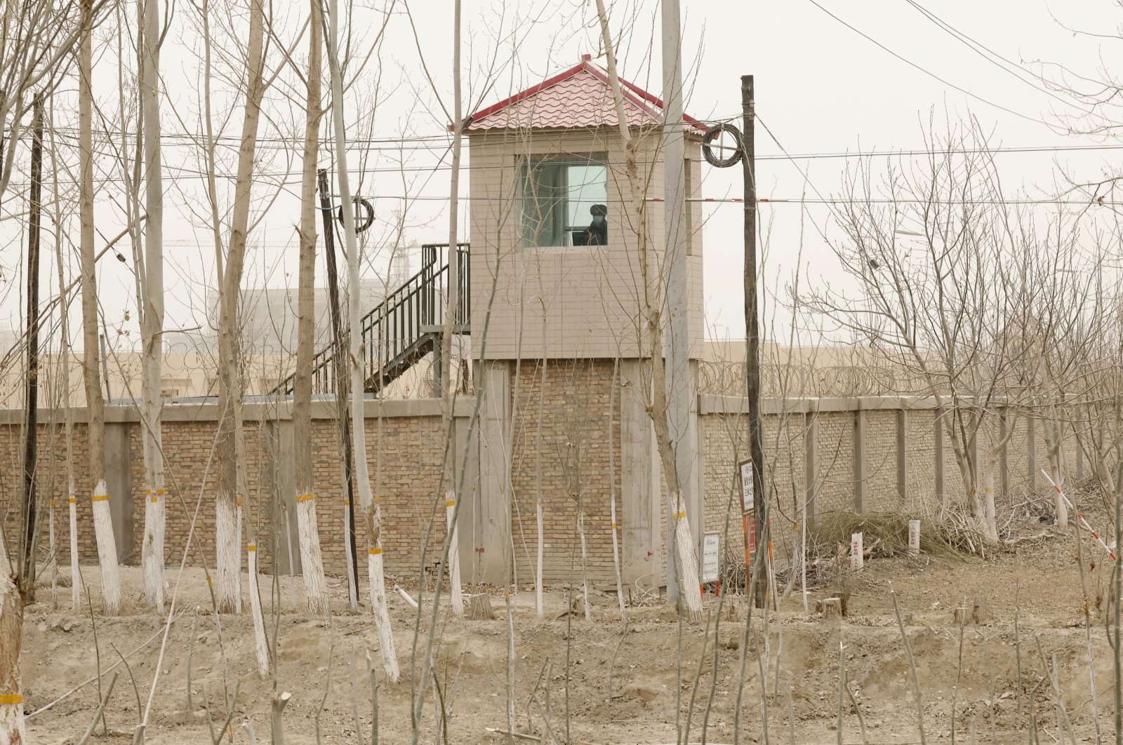 A security guard watches from a tower around a &quot;re-education&quot; facility in Yarkent County in northwestern China&#039;s Xinjiang Uyghur Autonomous Region, March 21, 2021. (AP File Photo)