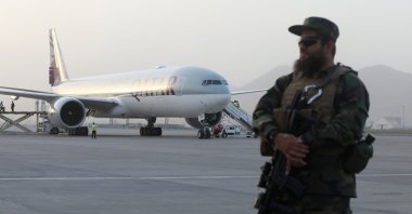 A member of Taliban security forces stands guard in front of a Qatar Airways airplane at the international airport in Kabul, Afghanistan, Sept. 10, 2021. (Reuters Photo)