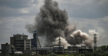Smoke and dirt are thrown into the air after a strike at a factory in the city of Soledar in the eastern region of Donbass, Ukraine, May 24, 2022, (AFP Photo)
