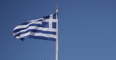 The Greek flag waves as two warplanes fly over the Holy Church of Panagia of Tinos on the Aegean island of Tinos, Greece, Aug. 15, 2020.  (AP File Photo)