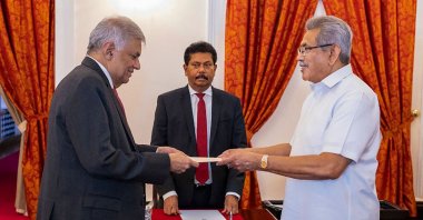 Sri Lanka's President Gotabaya Rajapaksa (R) swears in Prime Minister Ranil Wickremesinghe (L) as the new finance minister, in Colombo, Sri Lanka, May 25, 2022. (Sri Lanka's President's Office via AFP)