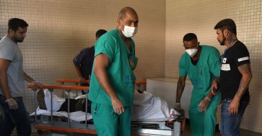 The corpse of a victim is carried on a stretcher at the Getulio Vargas Hospital, after an operation at a favela, Rio de Janeiro, Brazil, May 24, 2022. (AFP Photo)