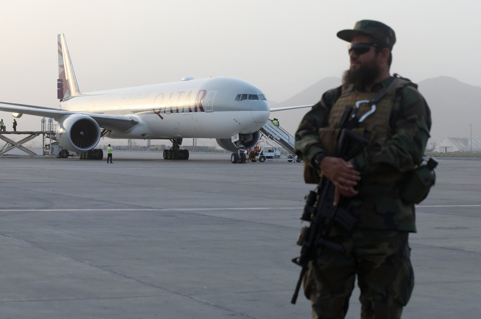 A member of Taliban security forces stands guard in front of a Qatar Airways airplane at the international airport in Kabul, Afghanistan, Sept. 10, 2021. (Reuters Photo)