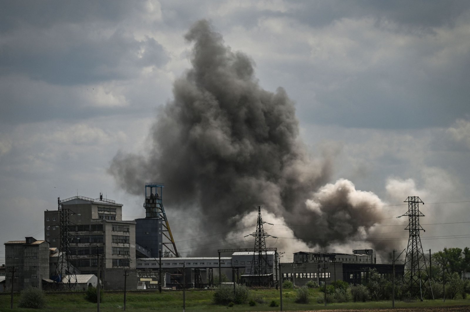 Smoke and dirt are thrown into the air after a strike at a factory in the city of Soledar in the eastern region of Donbass, Ukraine, May 24, 2022, (AFP Photo)