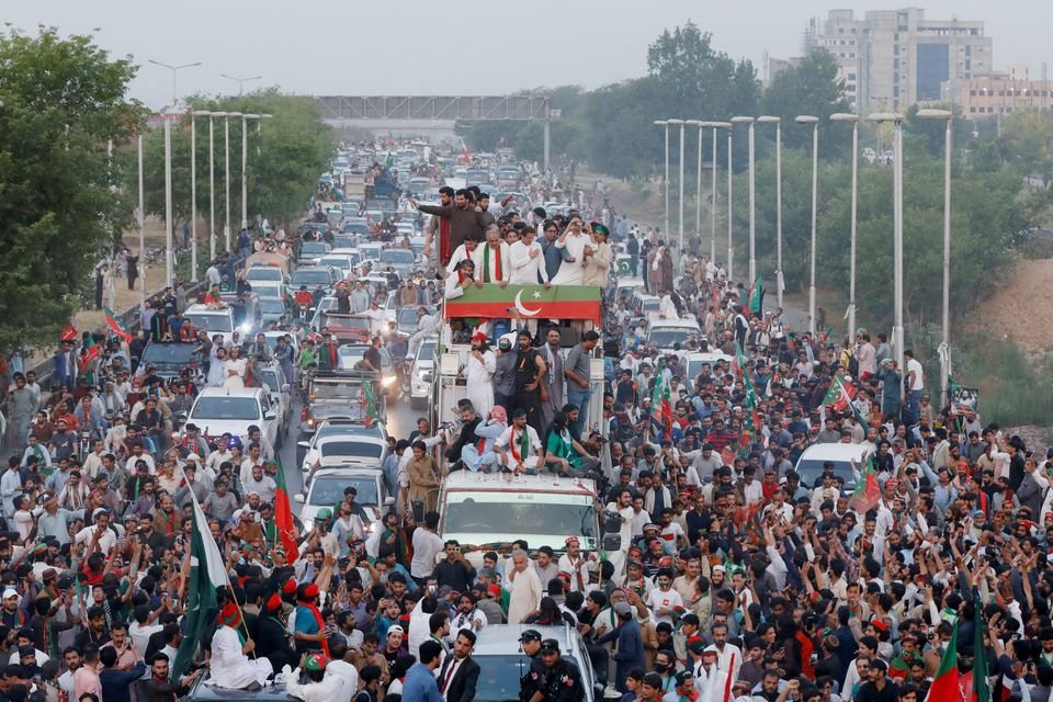 Ousted Pakistani Prime Minister Imran Khan gestures as he travels on a vehicle to lead a protest march in Islamabad, Pakistan, May 26, 2022. (Reuters Photo)