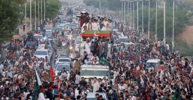 Ousted Pakistani Prime Minister Imran Khan gestures as he travels on a vehicle to lead a protest march in Islamabad, Pakistan, May 26, 2022. (Reuters Photo)