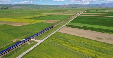 The Vangölü Express travels through a field in Turkey, May 26, 2022. (AA Photo)