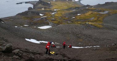 Scientists from the University of Chile collect organic material as they look for a bacteria discovered in Antarctica, Jan. 13, 2019. (Reuters Photo)