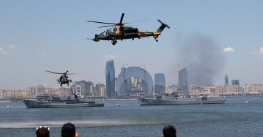 Two T129 Tactical Reconnaissance and Attack Helicopters (ATAK) (bottom) stage a show in Baku as part of Teknofest, Turkey’s largest aerospace and technology event, Azerbaijan, May 26, 2022. (AA Photo)