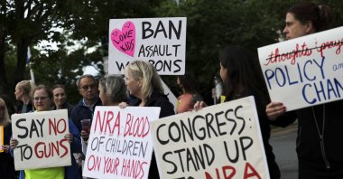 Gun-control advocates hold a vigil outside of the National Rifle Association (NRA) headquarters following the recent mass shooting at Robb Elementary School, Virginia, U.S., May 25, 2022. (AFP Photo)