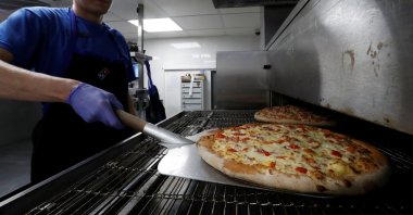 A staff member prepares pizzas at a Domino's Pizza restaurant in Moscow, Russia, July 14, 2017. (Reuters Photo)
