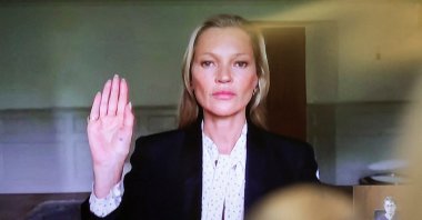 Model Kate Moss, a former girlfriend of actor Johnny Depp,  is sworn in to testify via video link during Depp&#039;s defamation trial against his ex-wife Amber Heard, at the Fairfax County Circuit Courthouse in Fairfax, Virginia, U.S., May 25, 2022. (Reuters Photo)