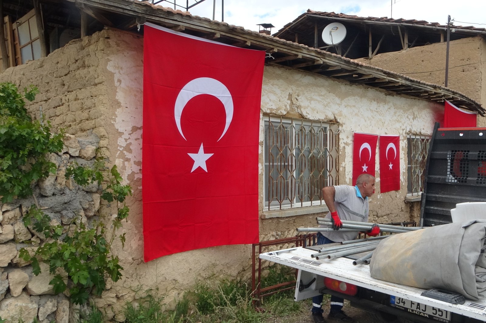 The family of the soldier killed by the PKK raised the Turkish flag at their home, Malatya, Turkey, May 24, 2022 (IHA Photo)  