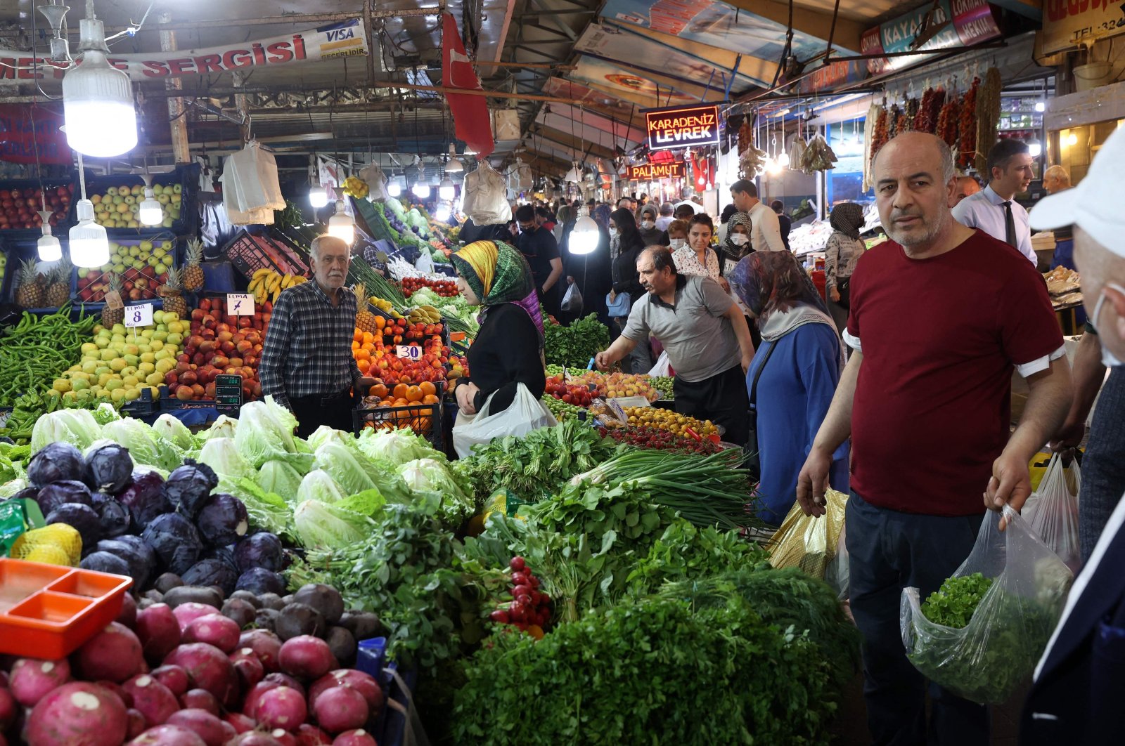 People shop at the vegetable and fruit market in the historical Ulus district of Ankara, Turkey, April 29, 2022. (AFP Photo)