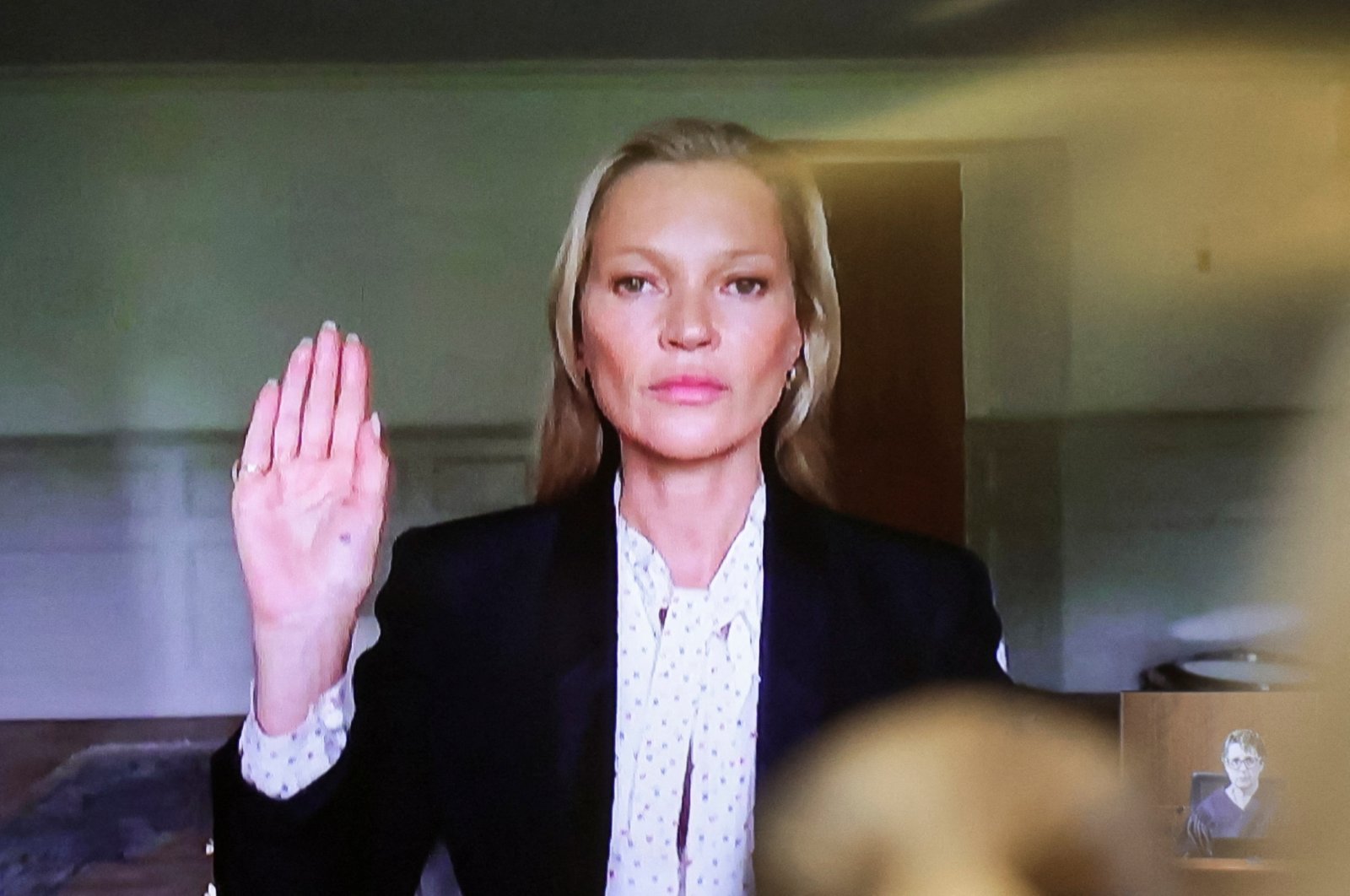 Model Kate Moss, a former girlfriend of actor Johnny Depp,  is sworn in to testify via video link during Depp&#039;s defamation trial against his ex-wife Amber Heard, at the Fairfax County Circuit Courthouse in Fairfax, Virginia, U.S., May 25, 2022. (Reuters Photo)