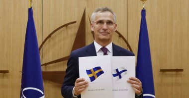 NATO Secretary-General Jens Stoltenberg displays documents as Sweden and Finland apply for membership in Brussels, Belgium, May 18, 2022. (AP Photo)