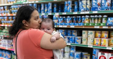 Yury Navas, 29, of Laurel, Md., kisses her two-month-old baby Ismael Galvaz, at Superbest International Market in Laurel, U.S., May 23, 2022, while looking for formula. (AP Photo/Jacquelyn Martin)