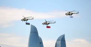 Helicopters with the national flags of Turkey and Azerbaijan fly over the capital Baku during the aerospace and technology festival Teknofest, Azerbaijan, May 27, 2022. (AA Photo)