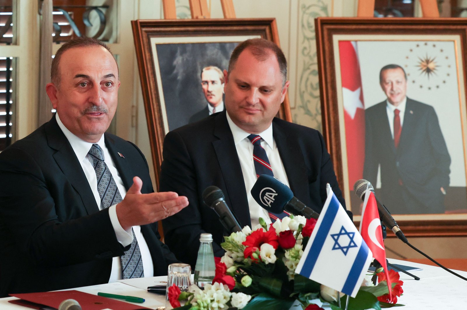 Foreign Minister Mevlüt Çavuşoğlu (L) delivers an opening statement before meeting with Israeli and Turkish business people, in Tel Aviv, Israel, May 25, 2022. (AFP Photo)