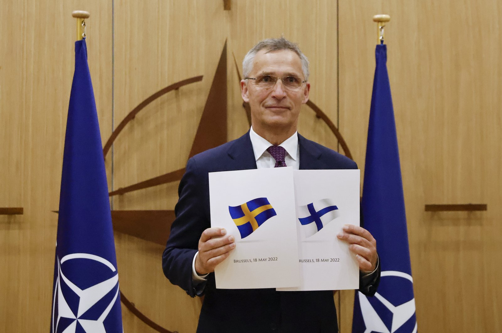 NATO Secretary-General Jens Stoltenberg displays documents as Sweden and Finland apply for membership in Brussels, Belgium, May 18, 2022. (AP Photo)