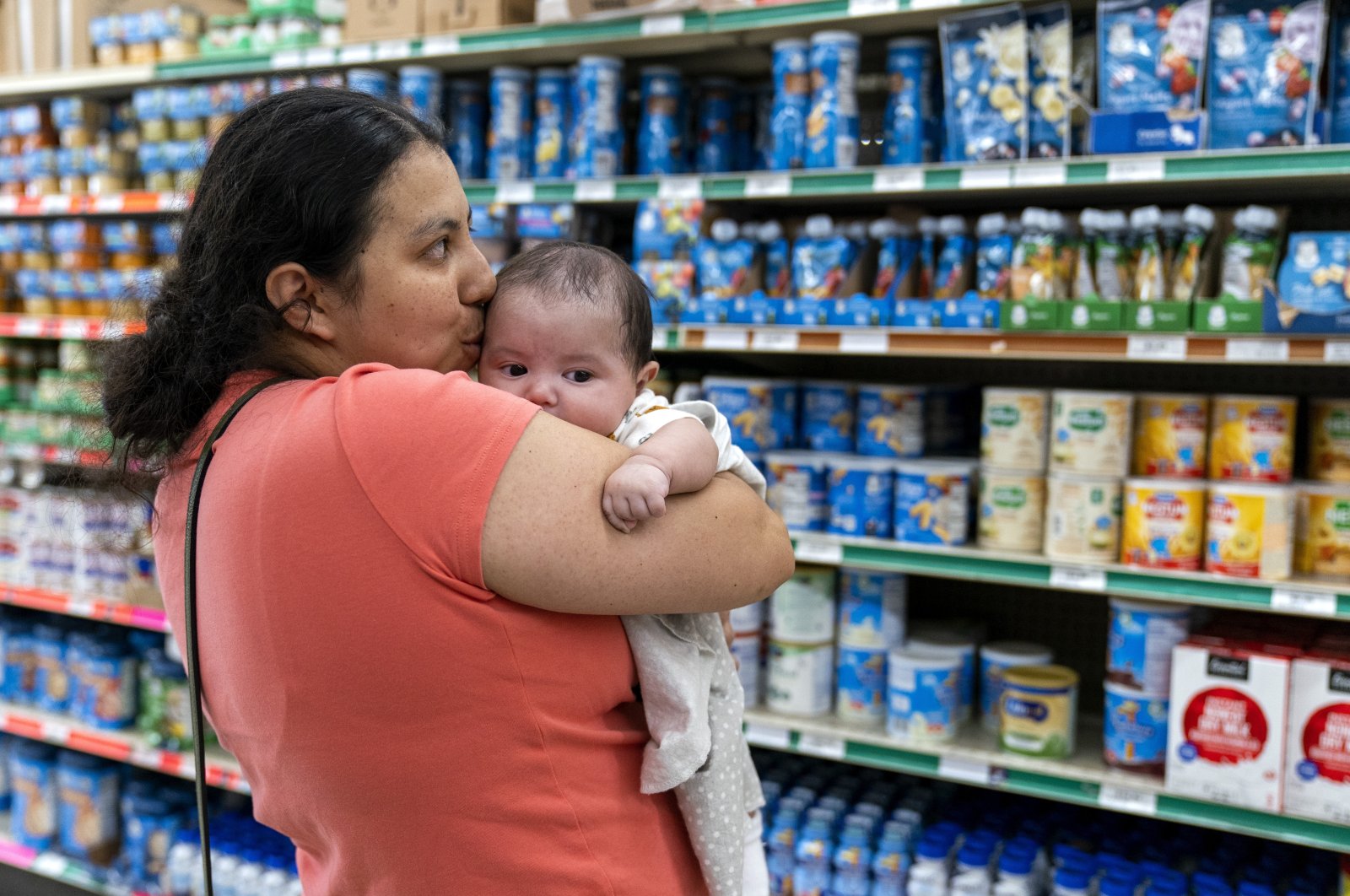 Yury Navas, 29, of Laurel, Md., kisses her two-month-old baby Ismael Galvaz, at Superbest International Market in Laurel, U.S., May 23, 2022, while looking for formula. (AP Photo/Jacquelyn Martin)