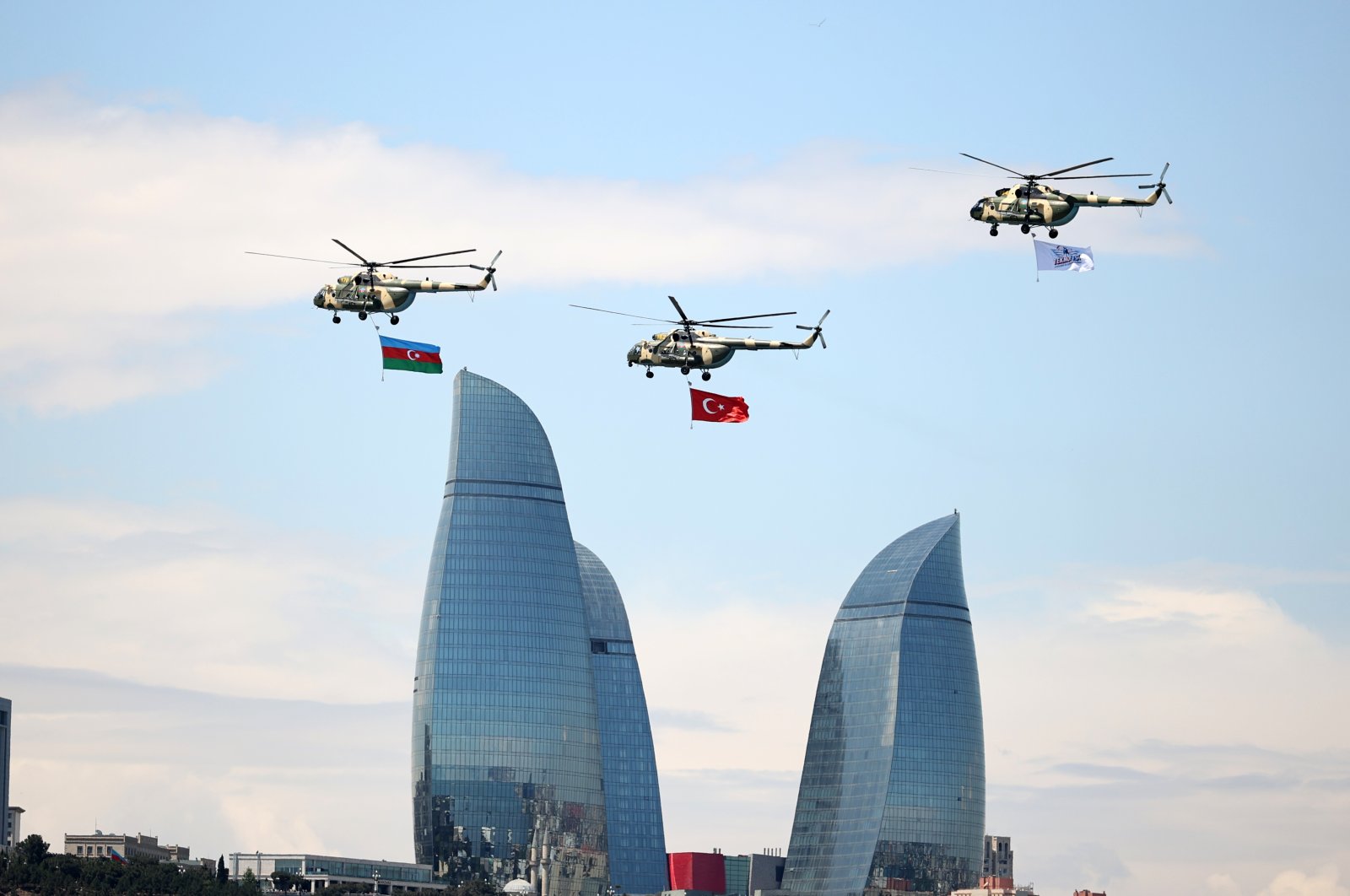Helicopters with the national flags of Turkey and Azerbaijan fly over the capital Baku during the aerospace and technology festival Teknofest, Azerbaijan, May 27, 2022. (AA Photo)