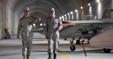 A handout photo made available by the Iranian military on May 28, 2022, shows Commander in Chief of the Iranian Army Maj. Gen. Abdolrahim Mousavi (R) and Armed Forces Chief of Staff Maj. Gen. Mohammad Bagheri (L) visiting an underground drone base, in an unknown location in Iran, May 19, 2022. (Iranian Army via EPA Photo)