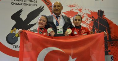 Weightlifters Şaziye Erdoğan and Cansu Bektaş on the podium with the Turkish flag at the European Championships in Tirana, Albania, May 28, 2022. (AA Photo)