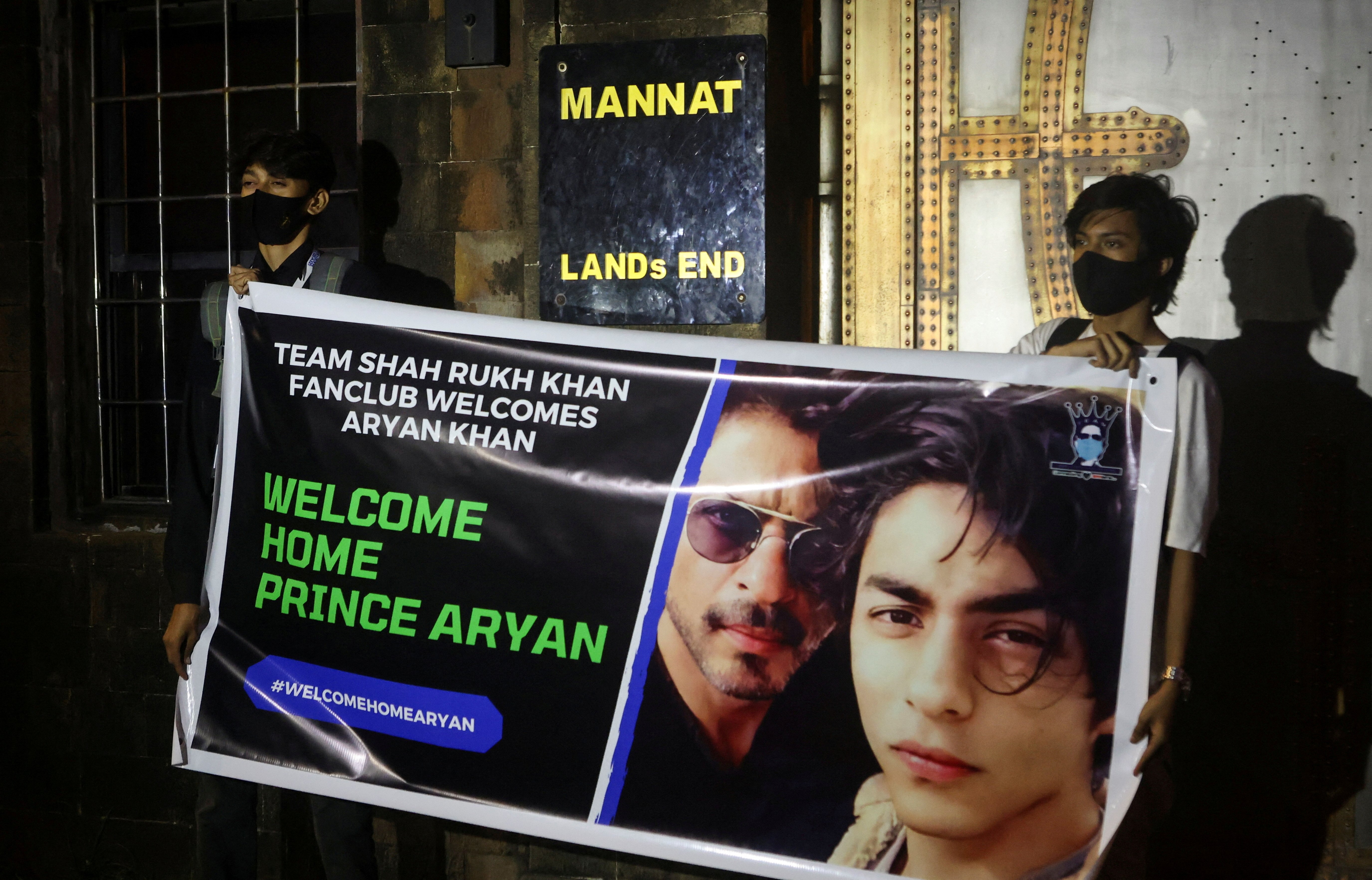 Fans of Bollywood superstar Shah Rukh Khan hold a poster outside his house, Mannat, after his eldest son Aryan Khan was granted bail by the Bombay High Court more than three weeks after he was arrested in a drugs case, in Mumbai, India, Oct. 28, 2021. (REUTERS File Photo)