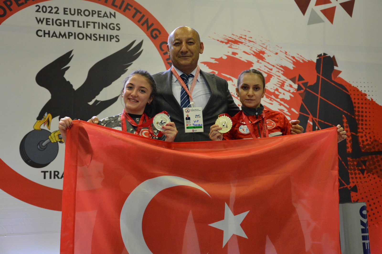 Weightlifters Şaziye Erdoğan and Cansu Bektaş on the podium with the Turkish flag at the European Championships in Tirana, Albania, May 28, 2022. (AA Photo)