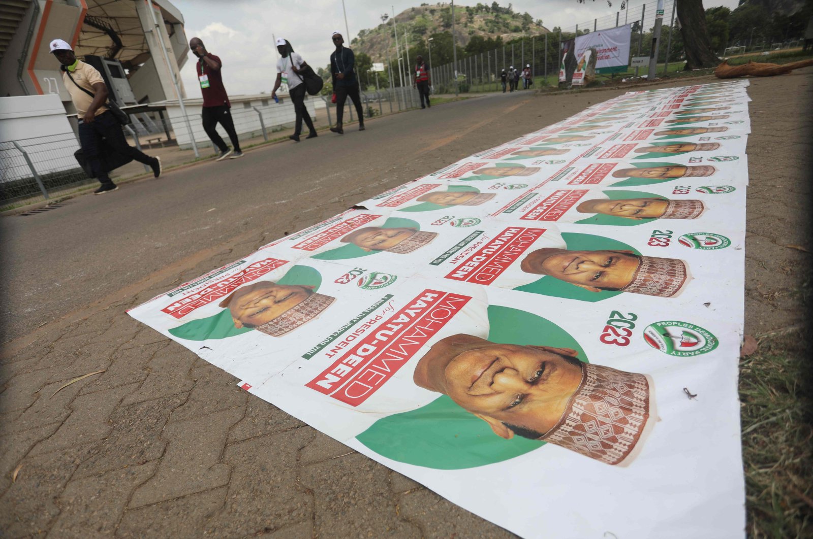 People walk past banners of Nigeria&#039;s opposition party, Peoples Democratic Party, at the Central Area, in Abuja, Nigeria, May 28 2022. (AFP Photo)