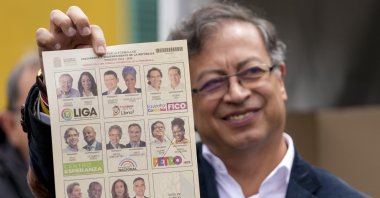 Gustavo Petro, a presidential candidate with the Historical Pact coalition, shows his ballot before voting during presidential elections in Bogota, Colombia, Sunday, May 29, 2022. (AP Photo)