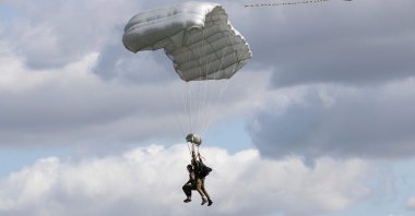 Tom Rice, a 98-year-old American WWII veteran, approaches the landing zone in a tandem parachute jump near Groesbeek, the Netherlands, Sept. 19, 2019. (AP Photo)
