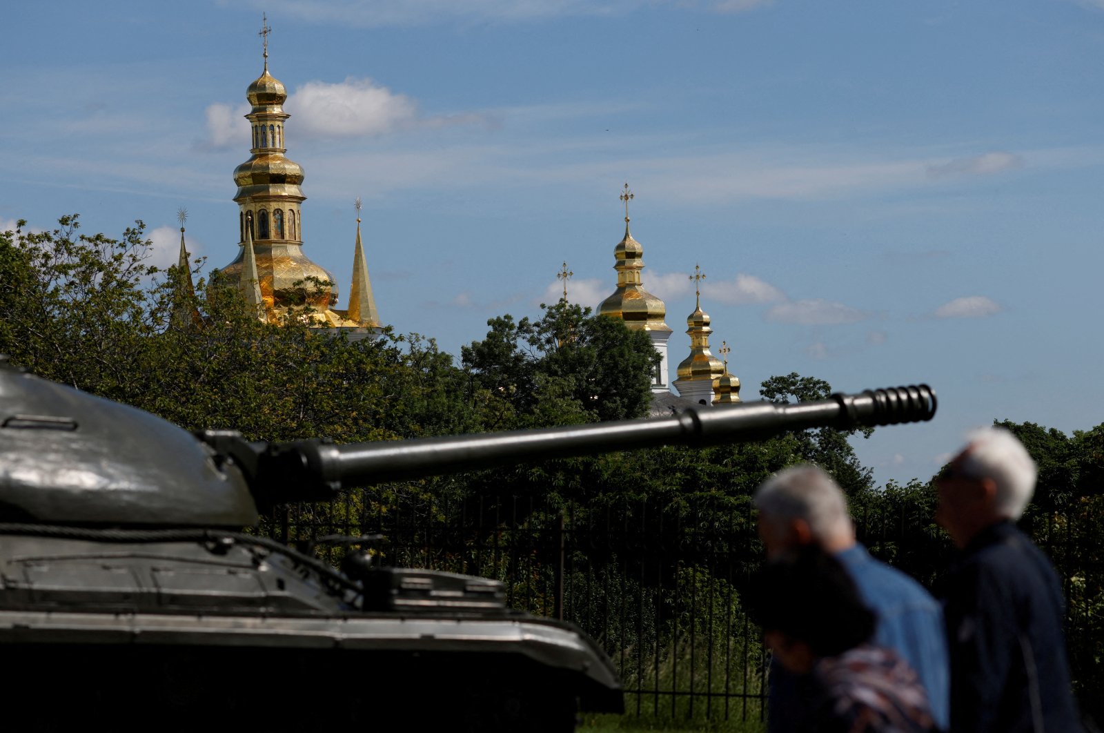 People pass a tank on display outside the compound of Kyiv Pechersk Lavra monastery, as Russia&#039;s attack on Ukraine continues, in Kyiv, Ukraine, May 29, 2022. (Reuters Photo)