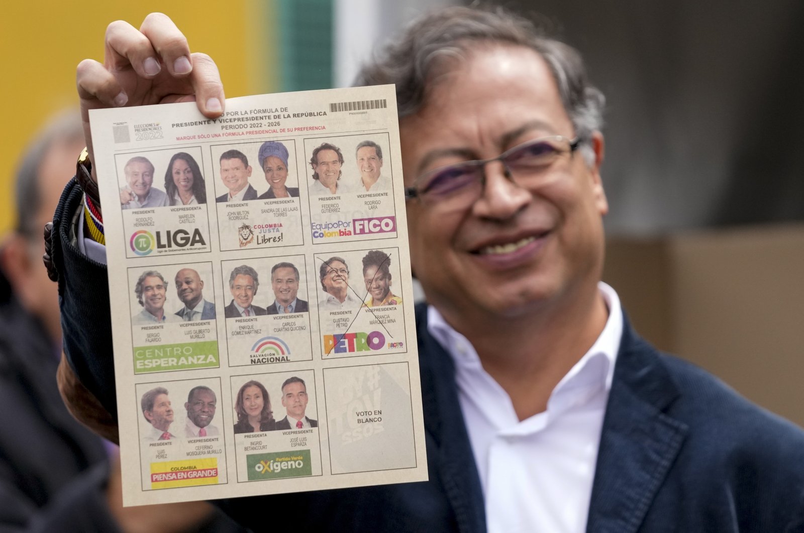 Gustavo Petro, a presidential candidate with the Historical Pact coalition, shows his ballot before voting during presidential elections in Bogota, Colombia, Sunday, May 29, 2022. (AP Photo)