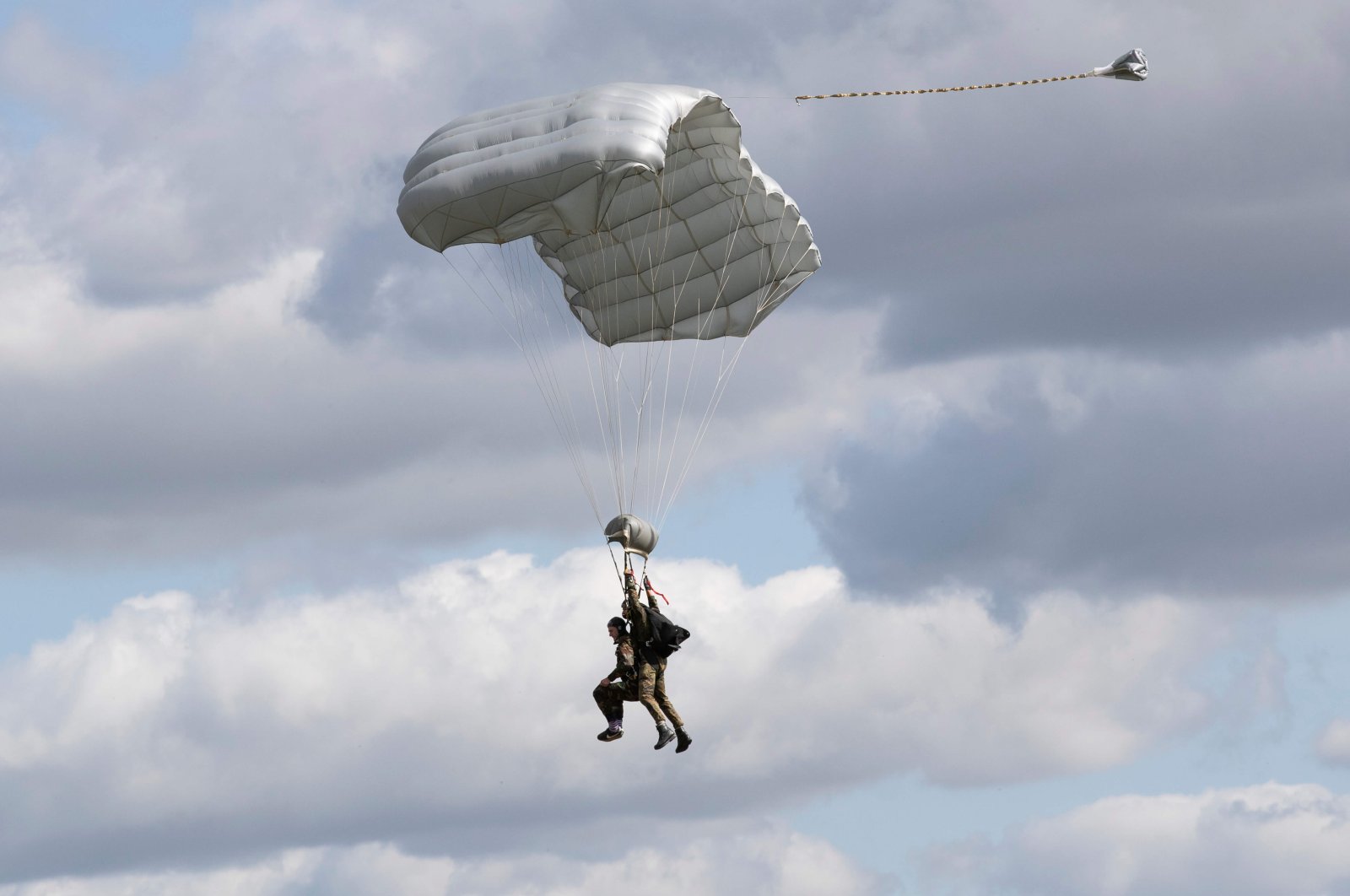 Tom Rice, a 98-year-old American WWII veteran, approaches the landing zone in a tandem parachute jump near Groesbeek, the Netherlands, Sept. 19, 2019. (AP Photo)