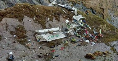 The wreckage of a plane in a gorge in Sanosware in Mustang district close to the mountain town of Jomsom, west of Kathmandu, Nepal, May 30, 2022. (Fishtail Air via AP)