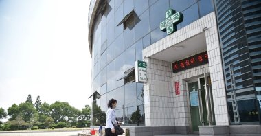 A woman walks into a pharmacy to purchase medicine in Pyongyang, North Korea, May 27, 2022. (AFP Photo)
