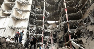 Iranians gather at the site where a 10-story building collapsed as rescue operations continue in the southwestern city of Abadan, Iran, May 24, 2022. (AFP Photo)
