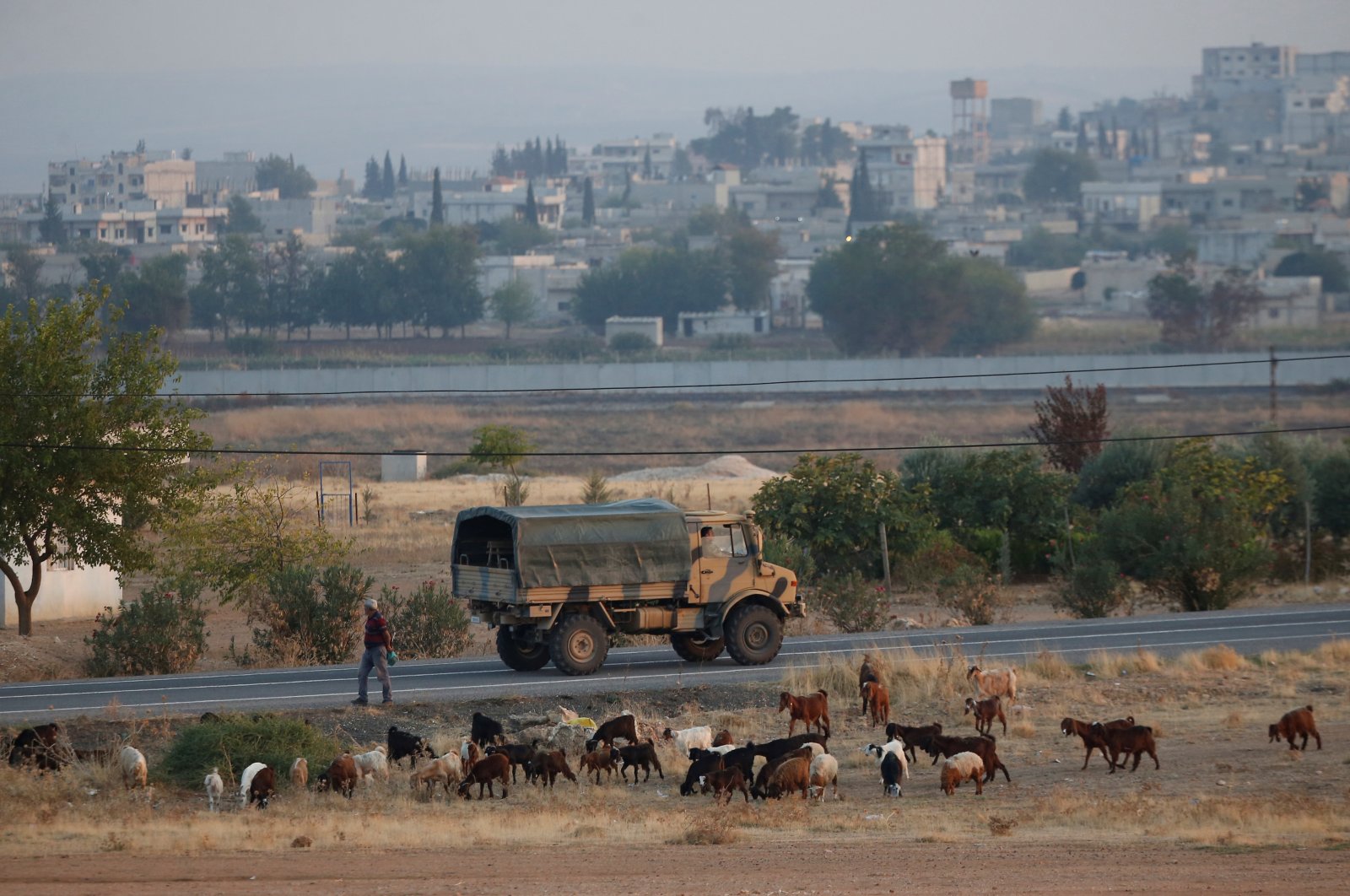 A Turkish military truck drives on the Turkish-Syrian border, with the Syrian town of Ain al-Arab in the background, in Suruç, Şanlıurfa province, Turkey, Oct. 31, 2019. (Reuters File Photo)