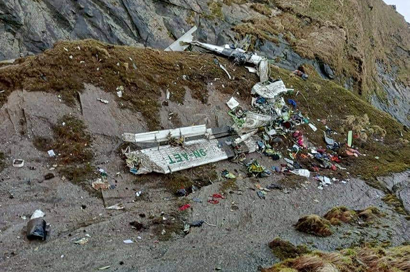 The wreckage of a plane in a gorge in Sanosware in Mustang district close to the mountain town of Jomsom, west of Kathmandu, Nepal, May 30, 2022. (Fishtail Air via AP)
